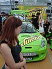 schoolgirl in front of tuned car